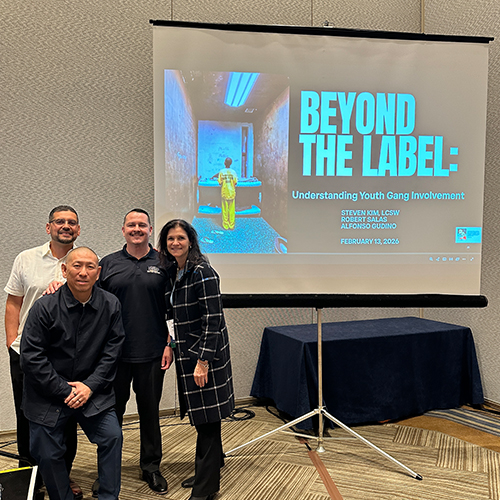Understanding Youth Gang Involvement Presentation at Healing Institute Four presenters, including Steven Kim, Robert Salas, and Alfonso Gudino, smile before their 'Beyond the Label' presentation…